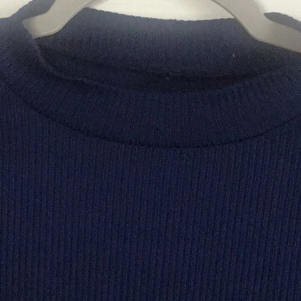 Fray features blue denim skirt with free knit top